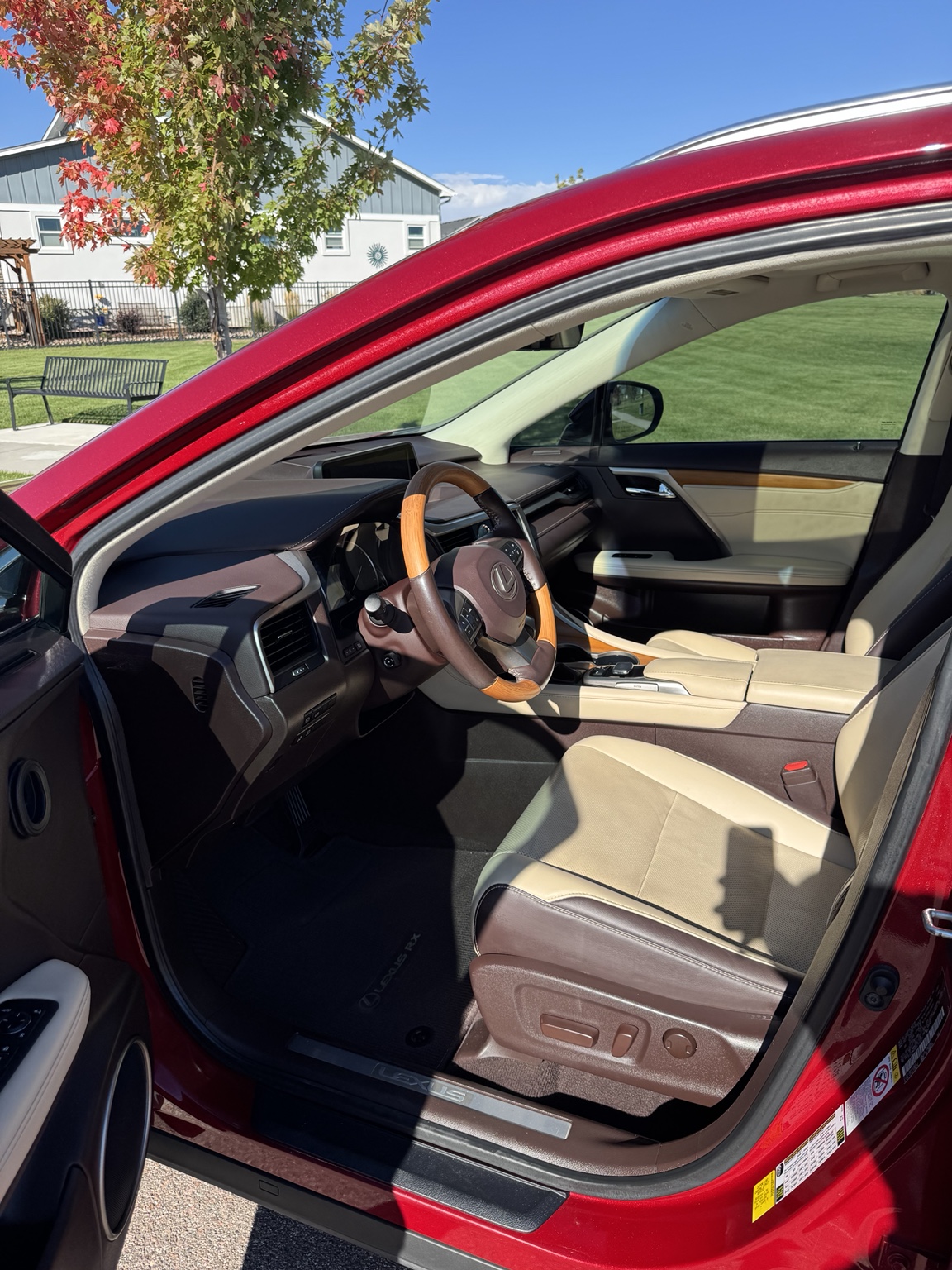 Lexus RX 350 driver’s area with cream and brown seating and wood trim